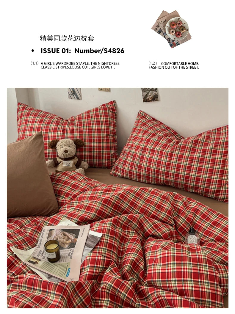 A red and green plaid duvet cover set with matching pillows and a stuffed bear toy.