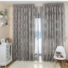 Gray sheer jacquard curtain panels hanging in a light-colored room.