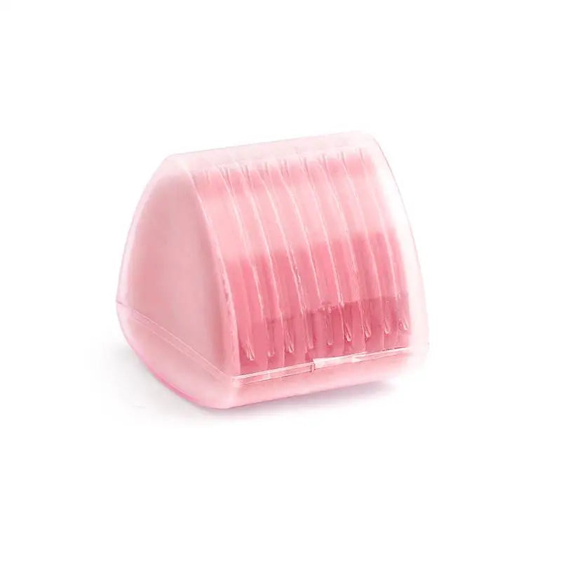 A pink, translucent plastic eraser tool with ridges used for fabric chalk markers.