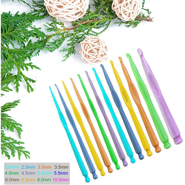 A set of twelve precision plastic crochet hooks in various sizes and colors displayed on a green foliage background.