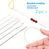 A set of seven beaded stainless steel needles for jewelry making shown next to a hand.