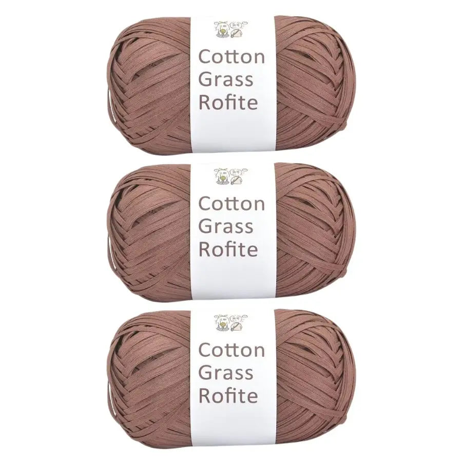 A set of natural cotton grass roving yarn in a dusty rose color, packaged with white labels.