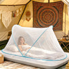 A portable mosquito net is set up inside a tent, providing a screened sleeping area for outdoor use.