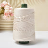 A spool of cream-colored 3mm ice rope crochet yarn with a dark green cap, displayed on a white surface.
