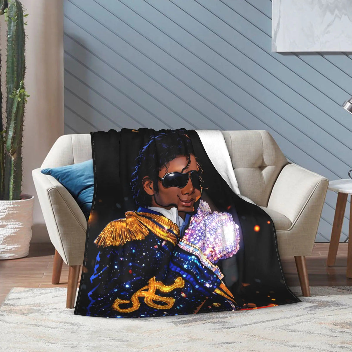 A black graphic throw blanket featuring a man with glowing eyes and ornate blue and gold armor.