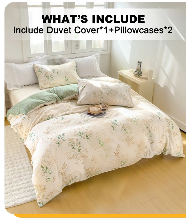 A bed set featuring an elegant floral tea art duvet cover, two pillowcases, and a green accent pillow on a light-colored bed.
