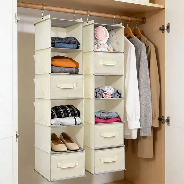 A light beige foldable hanging closet organizer with multiple compartments for storing folded clothes and accessories.