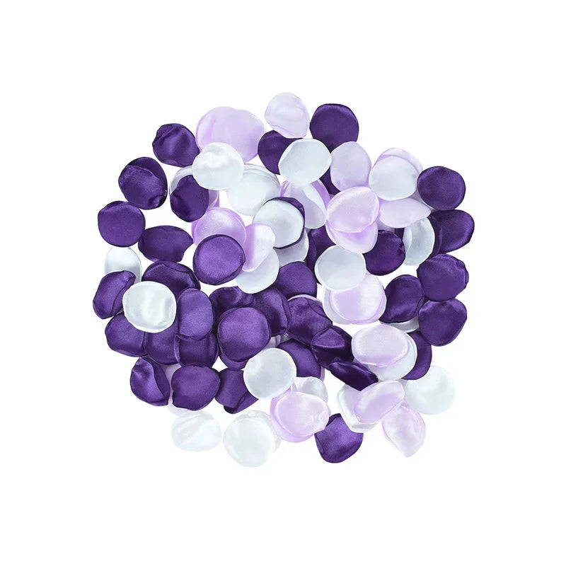 A collection of silk rose petals in shades of purple and white for weddings and events.