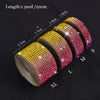 Rolls of pink and gold diamond rhinestone strips for DIY decor, showing various lengths.