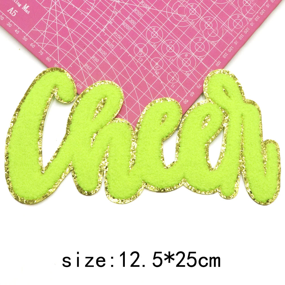 Bright lime green embroidered cheer letter patch on a pink grid background