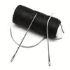 A roll of black hair extension weft threads with accompanying precision tools.