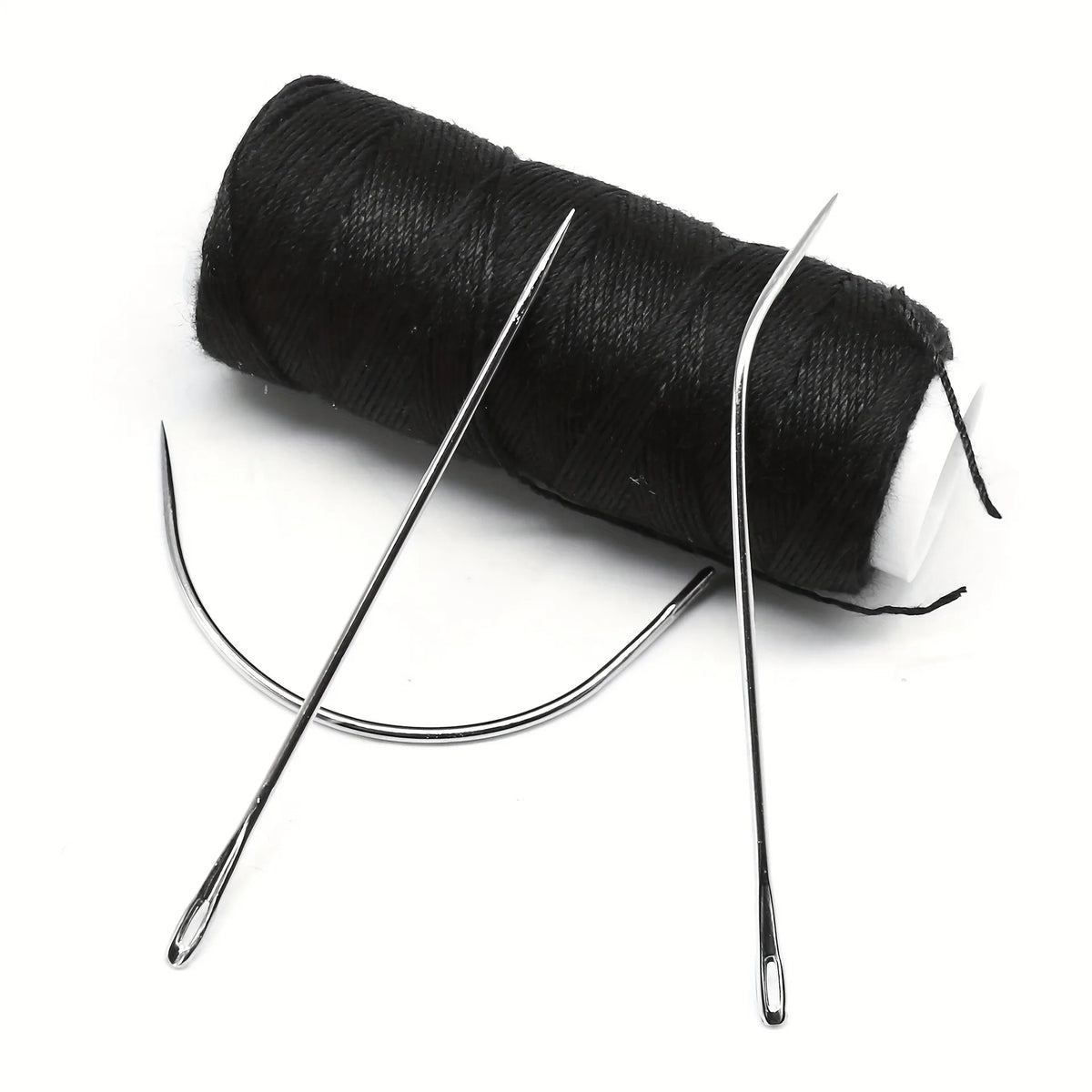 A roll of black hair extension weft threads with accompanying precision tools.