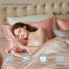 A woman rests on a pink silk pillow, demonstrating comfort and luxury in a bedroom setting.