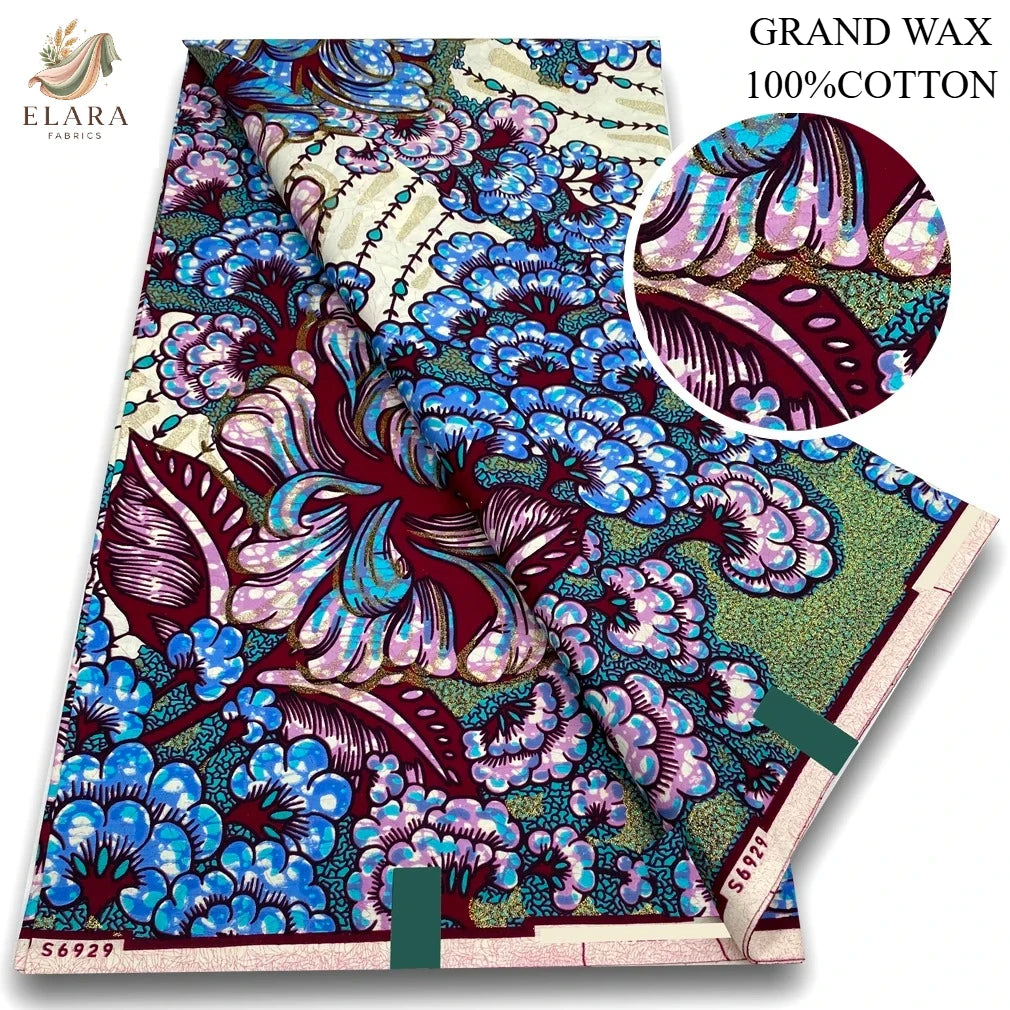 A bolt of grand wax print 100% cotton fabric featuring vibrant blue, purple, and green floral patterns.