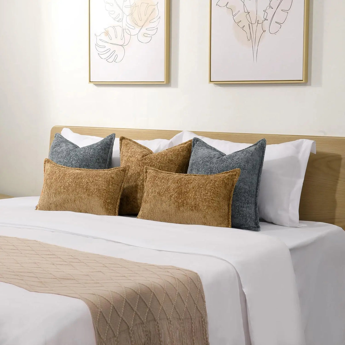 A collection of decorative chenille throw pillow covers in shades of beige, gray, and olive green on a white bed.