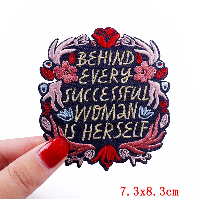 Pink letter embroidered iron-on patch with the text Behind Every Successful Woman Is Herself