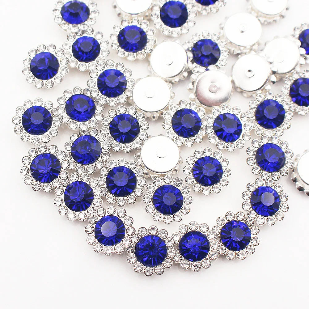 A close-up of silver and blue crystal rhinestone sew-on buttons arranged in a sunflower pattern.