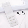 A white adjustable bra extender strap set with five small rings is displayed next to a picture frame.