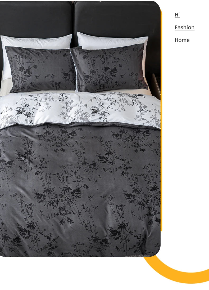 A set of three dark gray floral pattern duvet covers and pillowcases displayed on a bed.