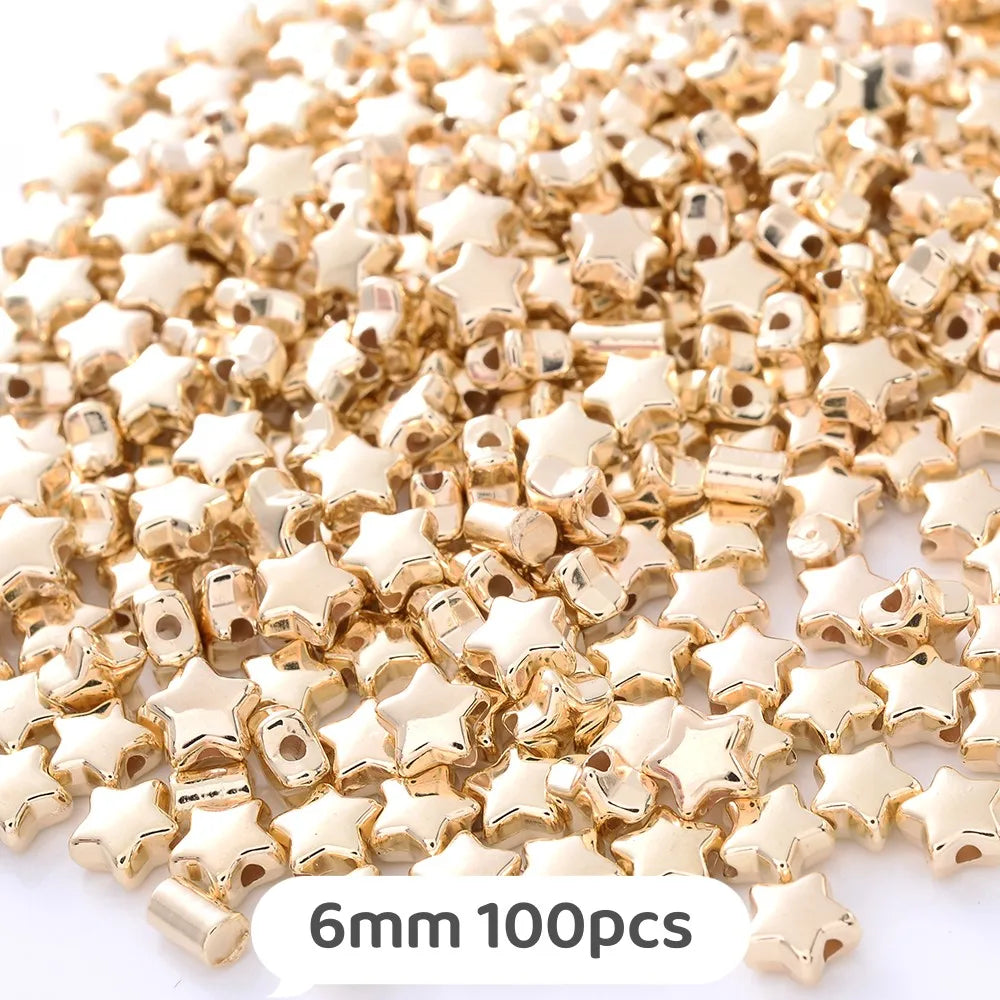 A pile of gold star-shaped acrylic beads for jewelry making, 6mm size, with 100 pieces.