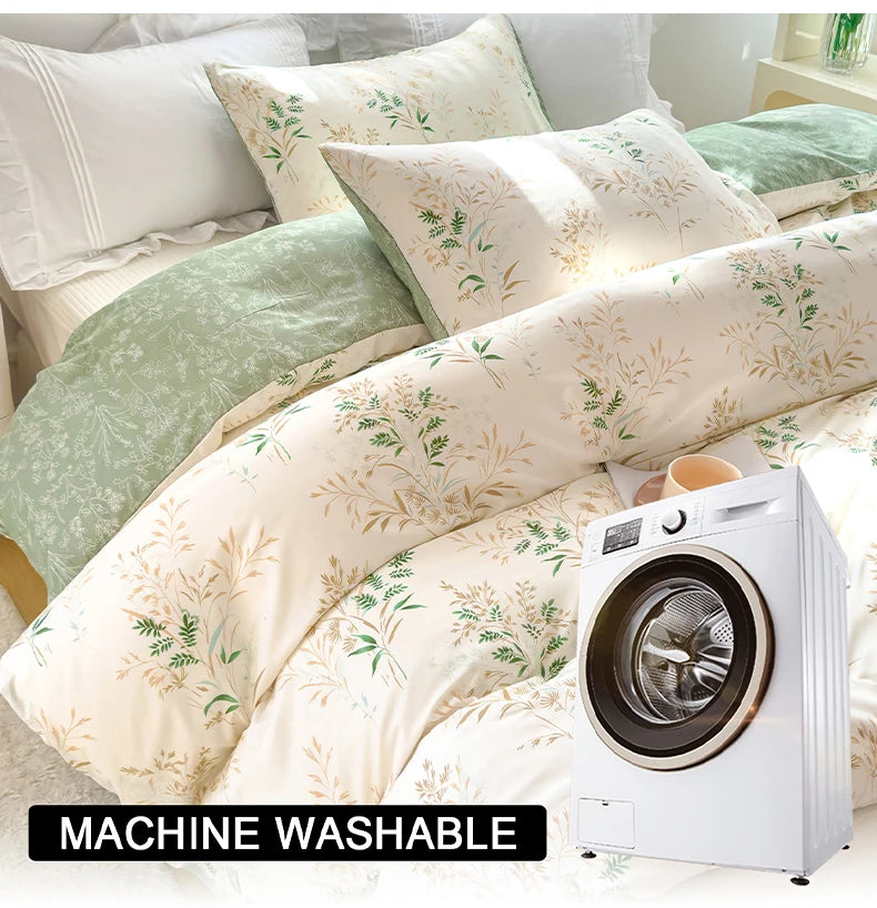 A white duvet cover set with a floral pattern featuring green leaves and light green accents, displayed on a bed.