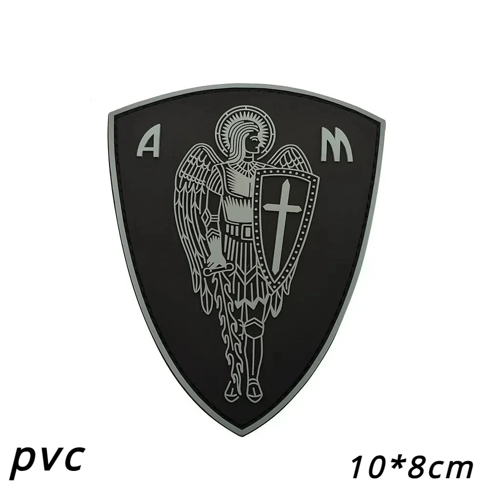 Black embroidered angel patch with silver lettering A M on a shield shape