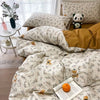 A close-up of a pink floral bedding set featuring patterned pillows and a duvet on a bed.