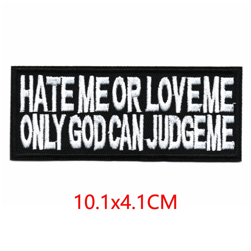 Black embroidered letter patch with white text that reads Hate Me or Love Me Only God Can Judge Me
