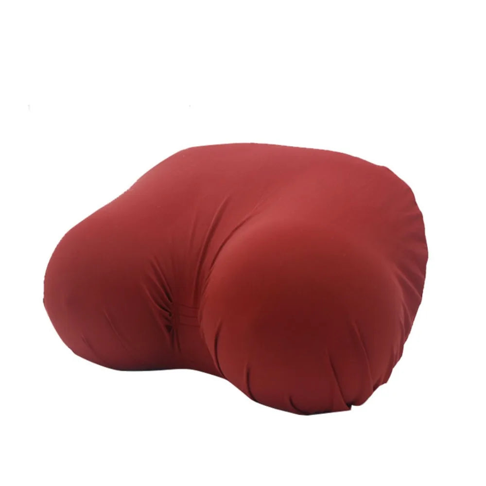 A reddish-brown memory foam contour chest pillow shown from the side.