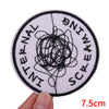 A round white patch with black embroidery spelling out INTERNAL SCREAMING