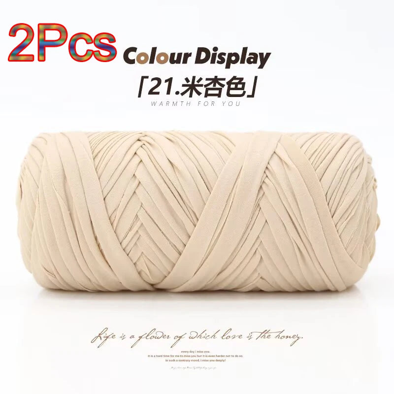 Two skeins of beige elastic yarn displayed in a coiled shape for crafting