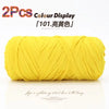 Two packs of yellow elastic yarn for crafting with a color display.