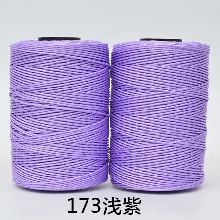 Two spools of purple hand knitting and crochet cord for crafting
