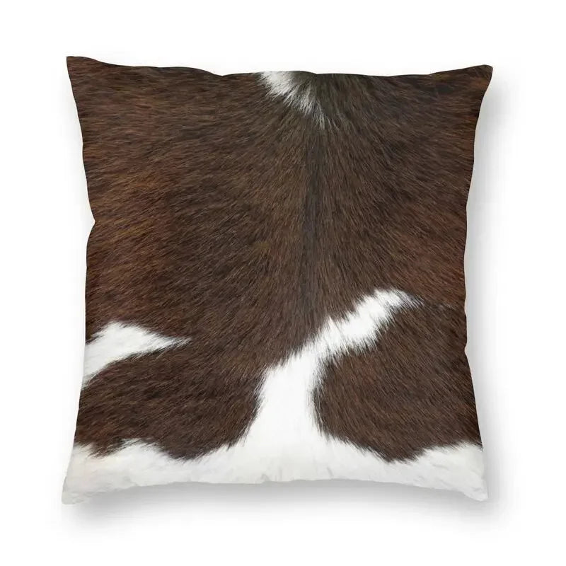 A square cushion cover featuring a brown and white cowhide print.