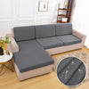 A gray waterproof sofa cushion protector cover is shown on a beige sofa.