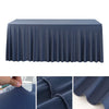 A dark blue stretchable waterproof rectangle tablecloth draped over a table.