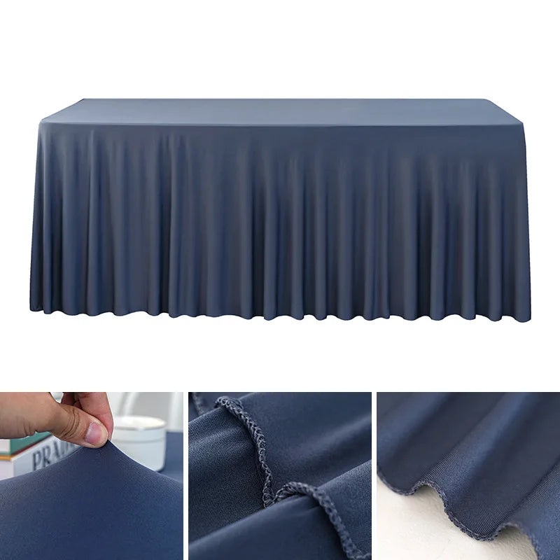 A dark blue stretchable waterproof rectangle tablecloth draped over a table.