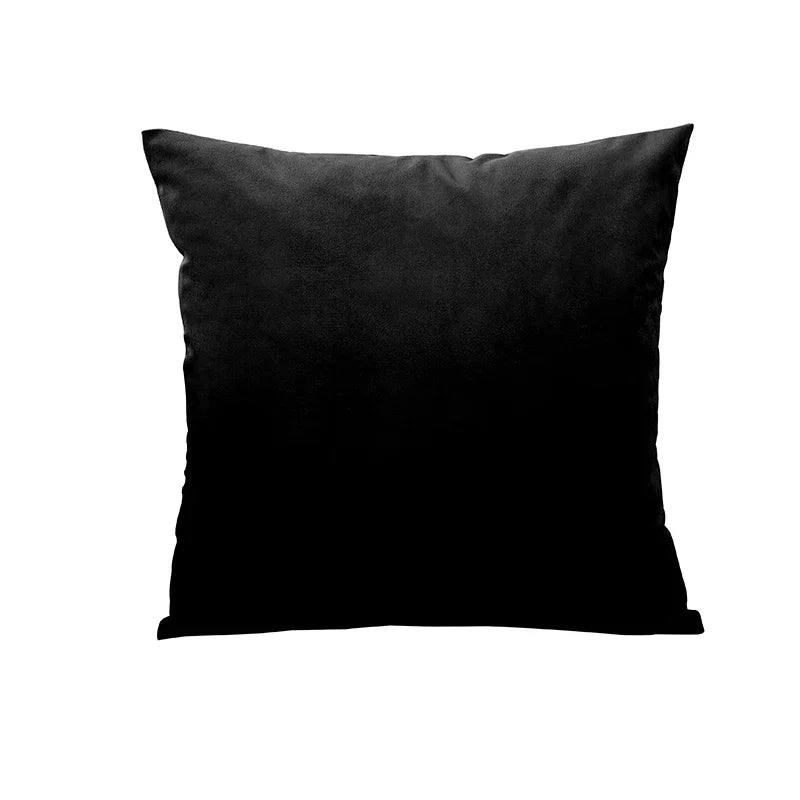 A black velvet throw pillow cover resting on a white background.