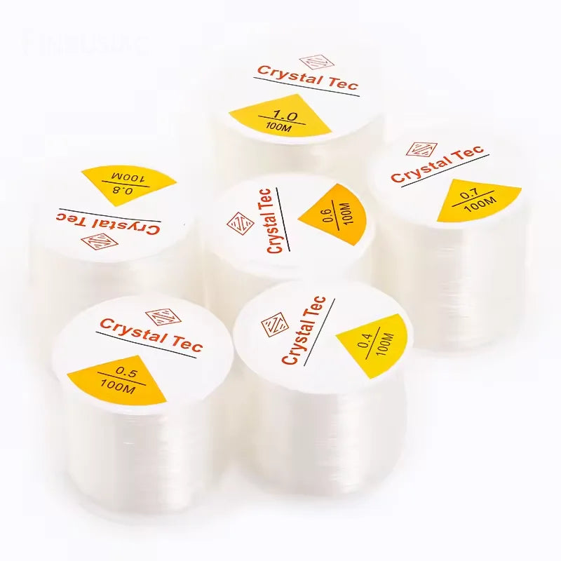 Rolls of transparent elastic cord for jewelry making with various diameters labeled on the packaging