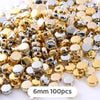 A pile of mixed gold and silver geometric acrylic beads for jewelry making