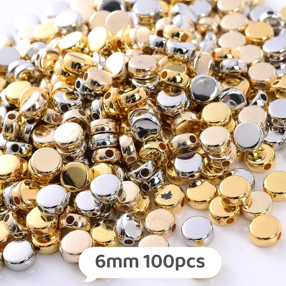 A pile of mixed gold and silver geometric acrylic beads for jewelry making