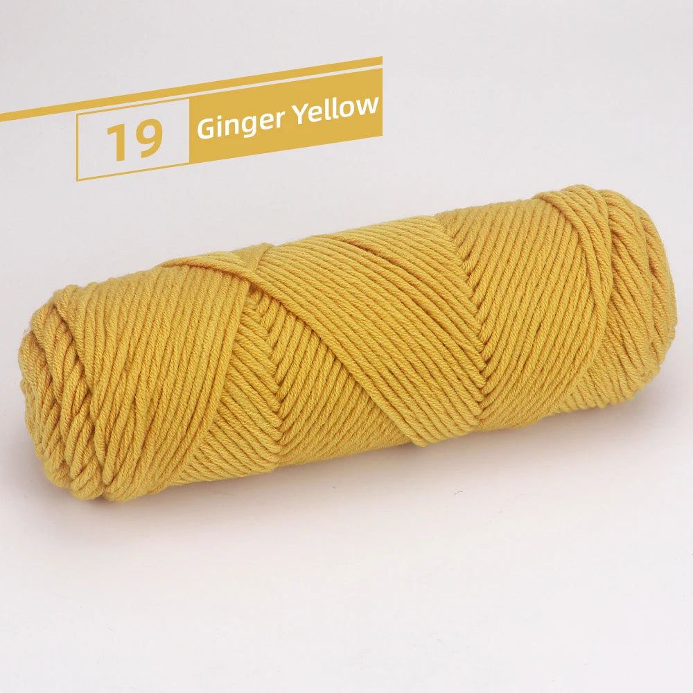 A skein of 19 Ginger Yellow premium worsted cotton yarn rolled tightly.