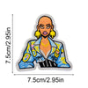An embroidered patch of a female character with orange skin, yellow hair, and a blue jacket.