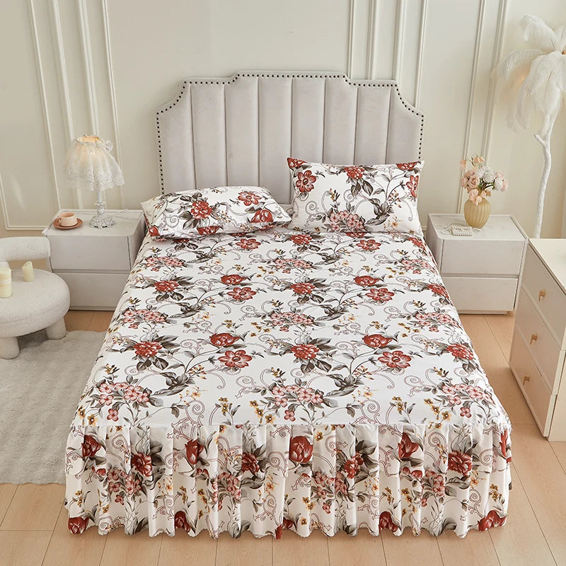 White floral ruffle bed skirt set with a detailed pattern displayed on a bed.