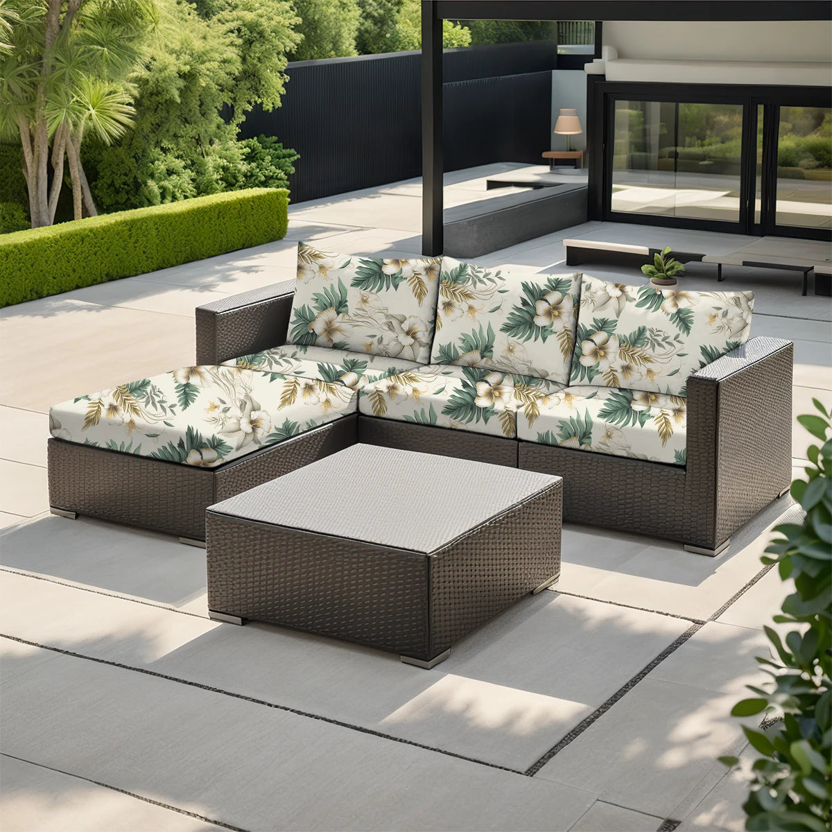 A dark brown outdoor sofa with floral patterned cushions placed on a light gray deck.