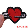 Red heart embroidered iron-on patch with a silver letter iron
