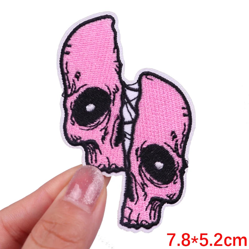 Pink embroidery patch featuring a stylized skull design