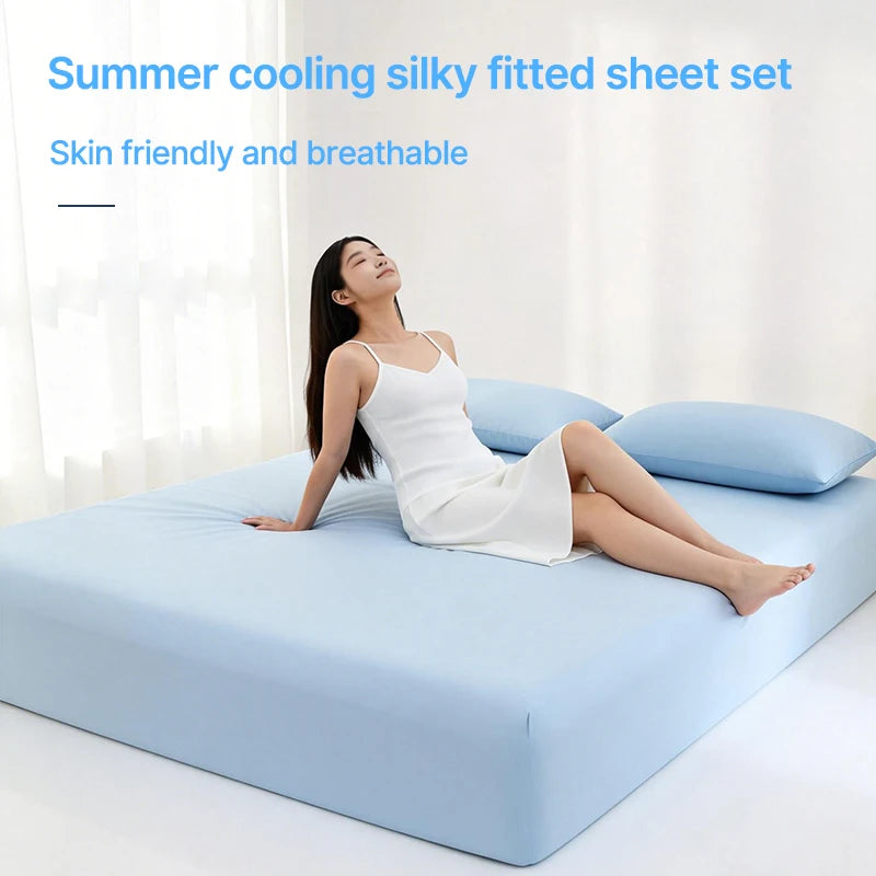 A woman is lying on a light blue bed with a white silky fitted sheet set, demonstrating the breathable fabric.