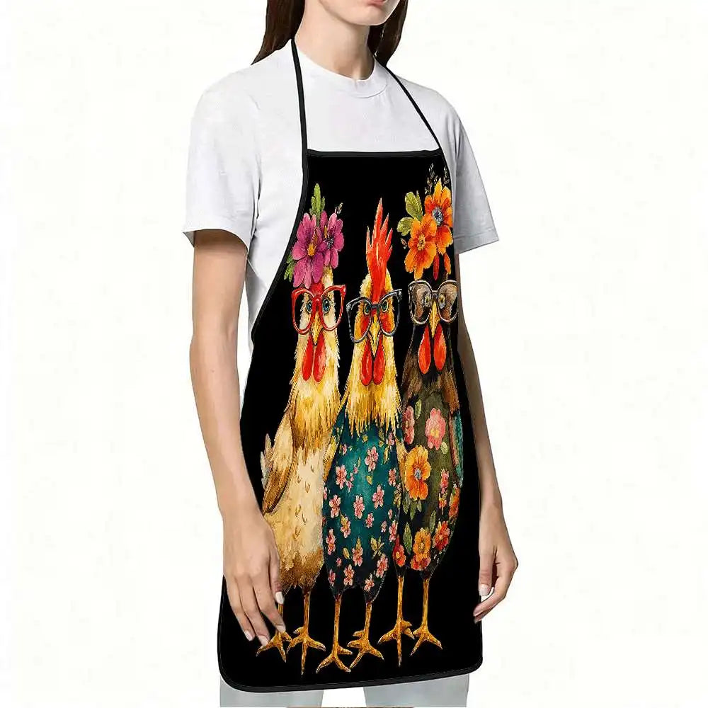 A woman wearing a black apron with a funny chicken floral print and glasses over a white t-shirt.