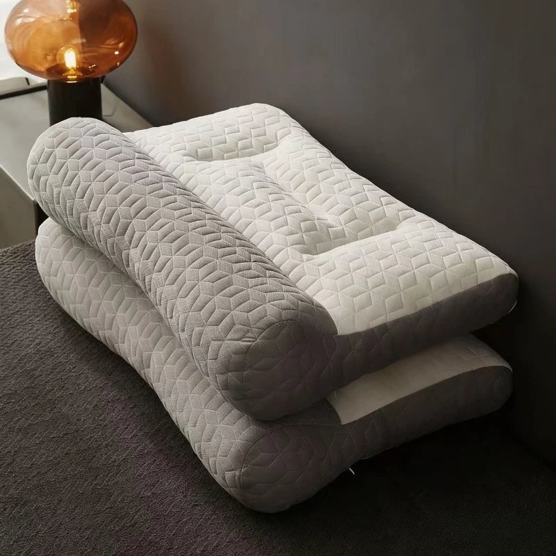 A stack of light gray and white 3D ergonomic contour pillows for neck and spine support resting on a dark carpet.